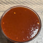 Bowl of J. Coleman's BBQ sauce on a wooden table