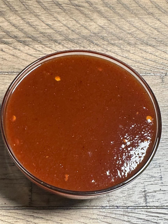 Bowl of J. Coleman's BBQ sauce on a wooden table