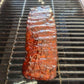 Meat glazed with J. Coleman's BBQ sauce cooking on the grill