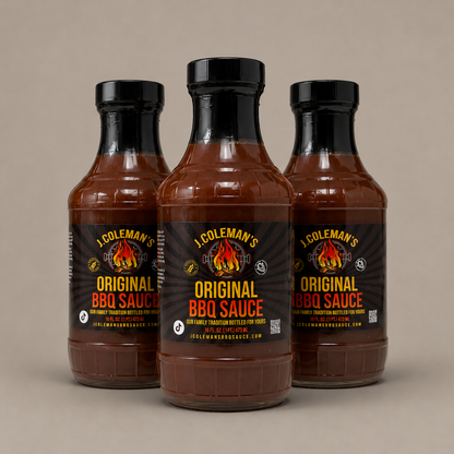 Three bottles of J. Coleman's Original BBQ Sauce arranged in a studio shot against a solid beige background, with the center bottle facing forward and the side bottles angled inward.